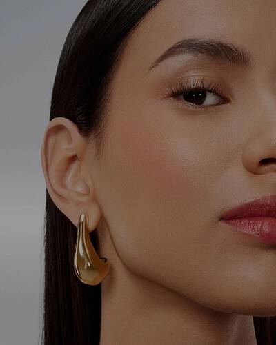Close-up of a model's face with bold eyebrows and defined lashes.