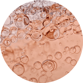 Bubbles rising in a sparkling, rose-colored liquid, creating a vibrant, effervescent texture.