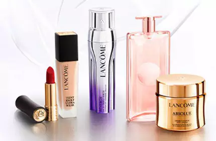 A collection of Lancome beauty products, including a lipstick, serum, perfume, and skincare cream, displayed elegantly against a light background.