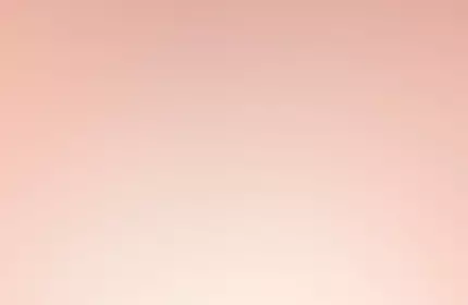 A close-up of a Lancome Nutrix Royal Body cream jar against a soft pink background. The jar features a gold lid and elegant branding.