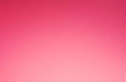 A red gift box with a ribbon, featuring the Lancome logo, set against a pink background.
