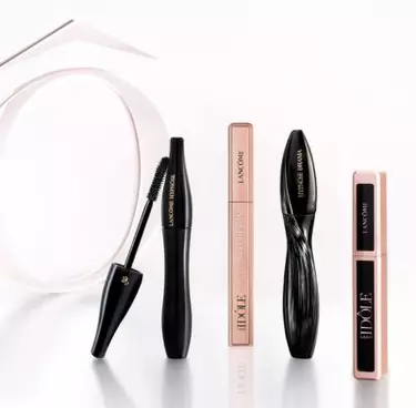 An image showcasing various Lancome mascaras and an eyeliner, including Lancome Hypnose, Idole Lash, and Hypnose Drama.
