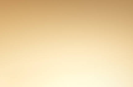 A close-up of two luxurious Lancome Absolue skincare bottles against a golden background.