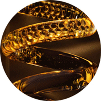 Close-up of a textured amber-colored spiral, reflecting light and creating a sense of fluidity and movement.
