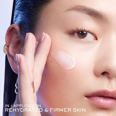 A woman feels her visibly smoother face after using Lancome's Peptide infused  Renergie  Multi Glow Cream