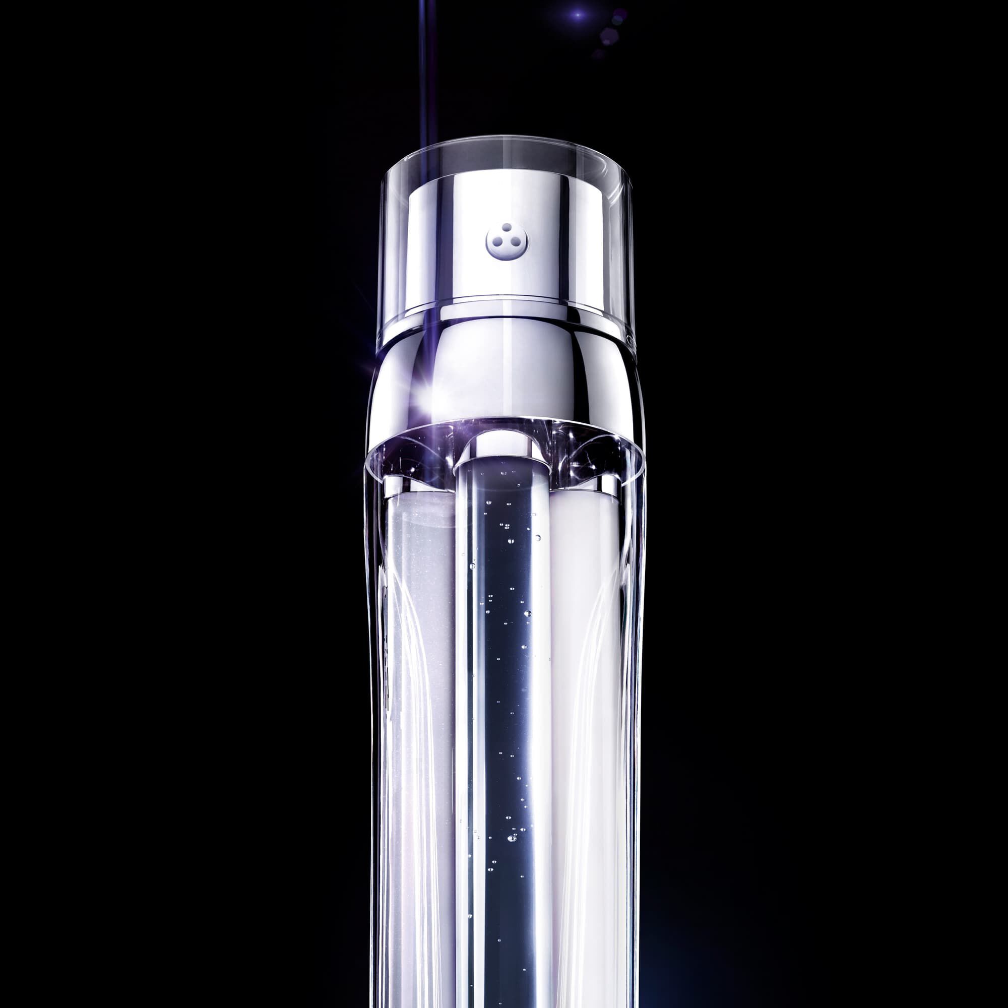 A close-up of a sleek, metallic tube with a transparent section, displaying liquid inside, all against a black background.