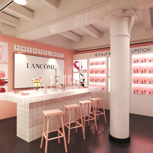 A bright and modern interior of a cosmetics store featuring pink walls, a white counter with makeup displays, and a bold blackboard. The space is well-lit and inviting, showcasing various beauty products.