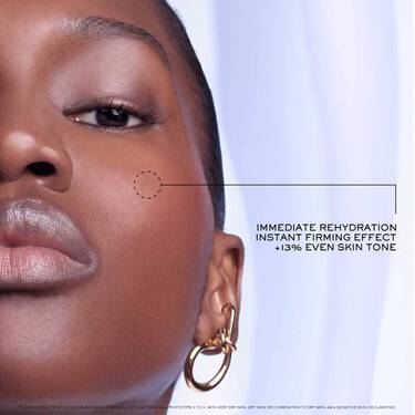 Close up of a woman applying Lancome's Renergie H.P.N 300 Peptide Rich Cream. Accompanying text says: In 1 application, REHYDRATED AND FIRMER SKIN.