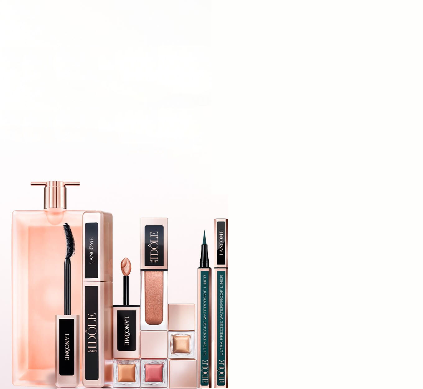 A collection of Lancome beauty products including a fragrance, mascara, lip gloss, eyeliner, and other cosmetics, arranged on a light background.
