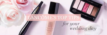A flat lay of Lancome beauty products, including a foundation bottle, eyeliner pen, and an eye shadow palette, surrounded by soft pink roses, with the text "Lancome's Top Tips for Your Wedding Day" overlaid.