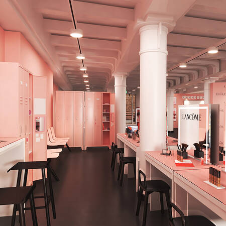 Interior of a modern beauty salon featuring soft pink walls, sleek white furniture, and elegant displays of beauty products. The space is well-lit with a spacious layout, creating a warm and inviting atmosphere.
