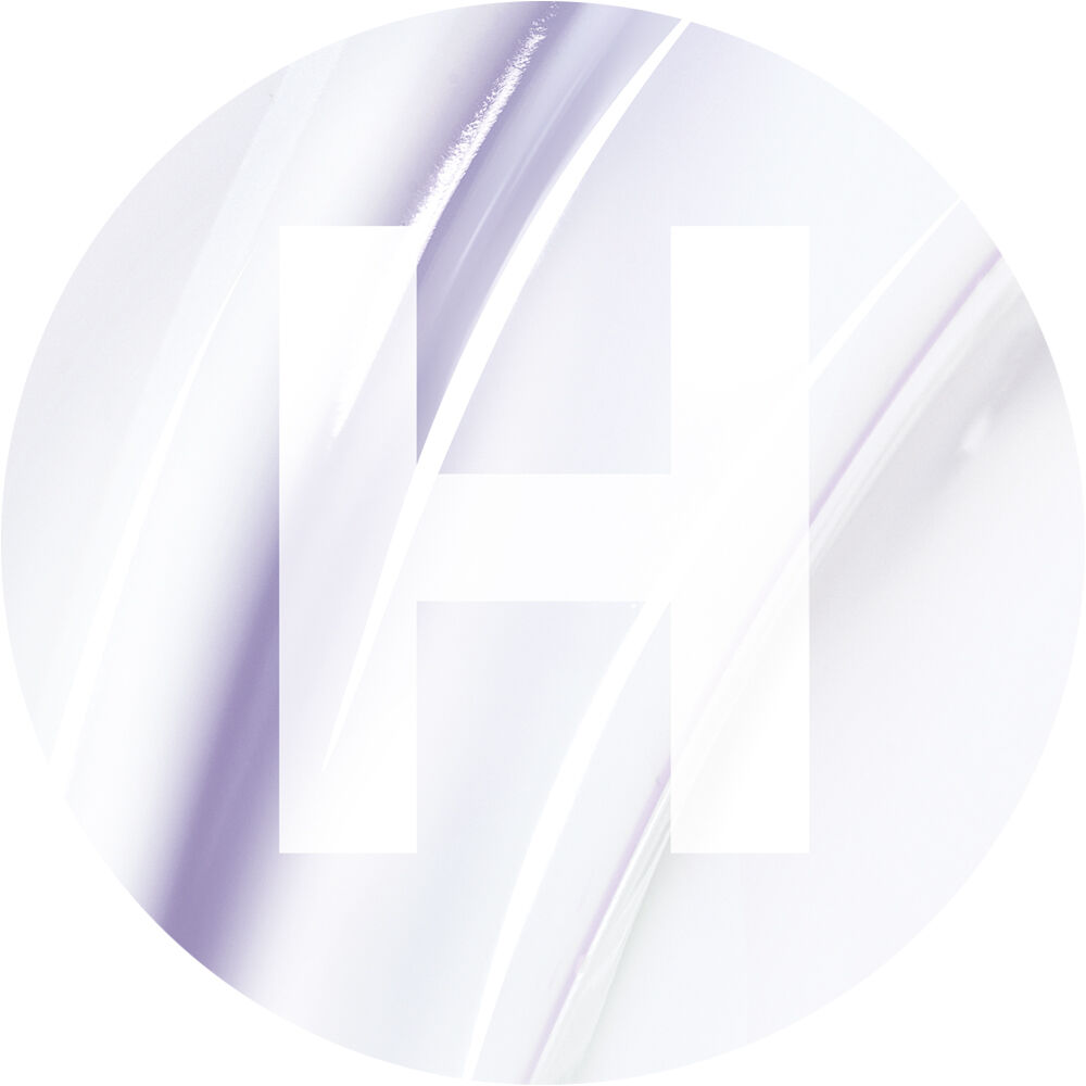 A circular design featuring a large, white letter "H" overlaid on a soft, abstract background of pale colors and smooth curves.