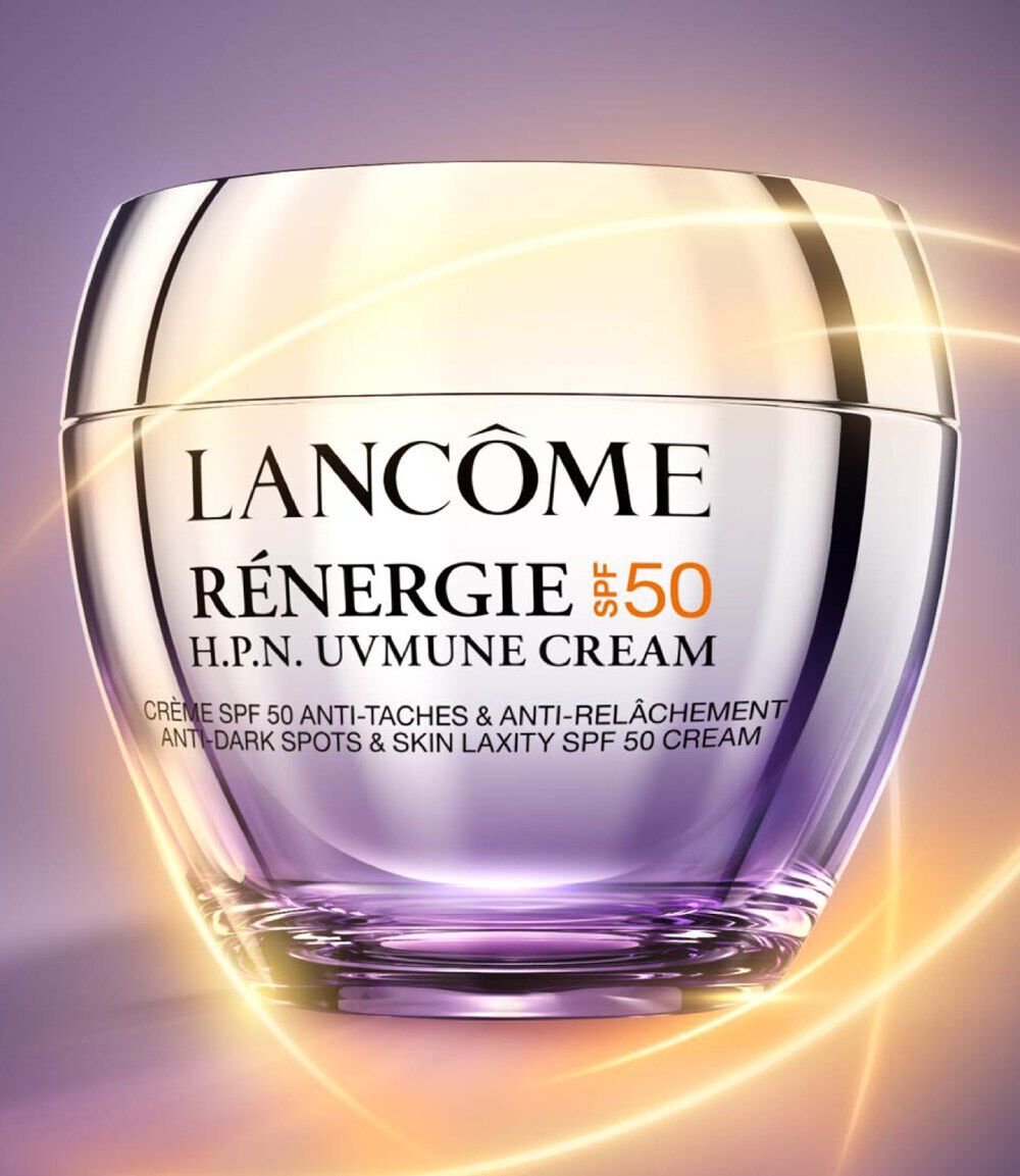 A jar of Lancome Renergie H.P.N. Uvimmune Cream with SPF 50, featuring a sleek, glossy design and a soft purple gradient background.