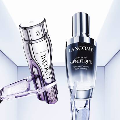 An artistic display of Lancome skincare products, including a serum and a cream, against a sleek, modern background.