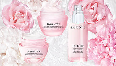 Three Lancome Hydra Zen products (cream-gel, cream, and liquid moisturizer) are arranged among pink and white flowers, suggesting a light and refreshing theme.