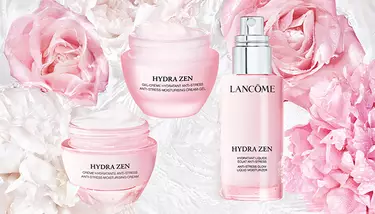 Three Lancome Hydra Zen products (cream-gel, cream, and liquid moisturizer) are arranged among pink and white flowers, suggesting a light and refreshing theme.
